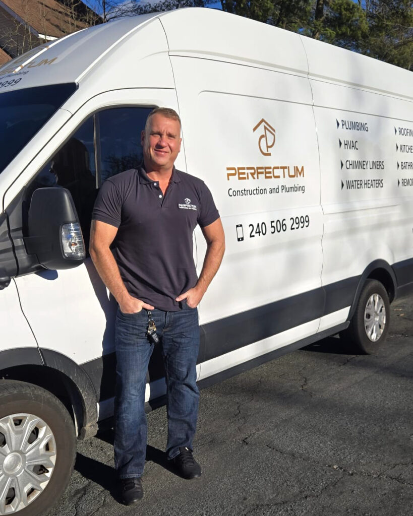 Home Perfectum Plumbing owner Vadim standing beside company van providing commercial plumbing and construction services in DMV area.