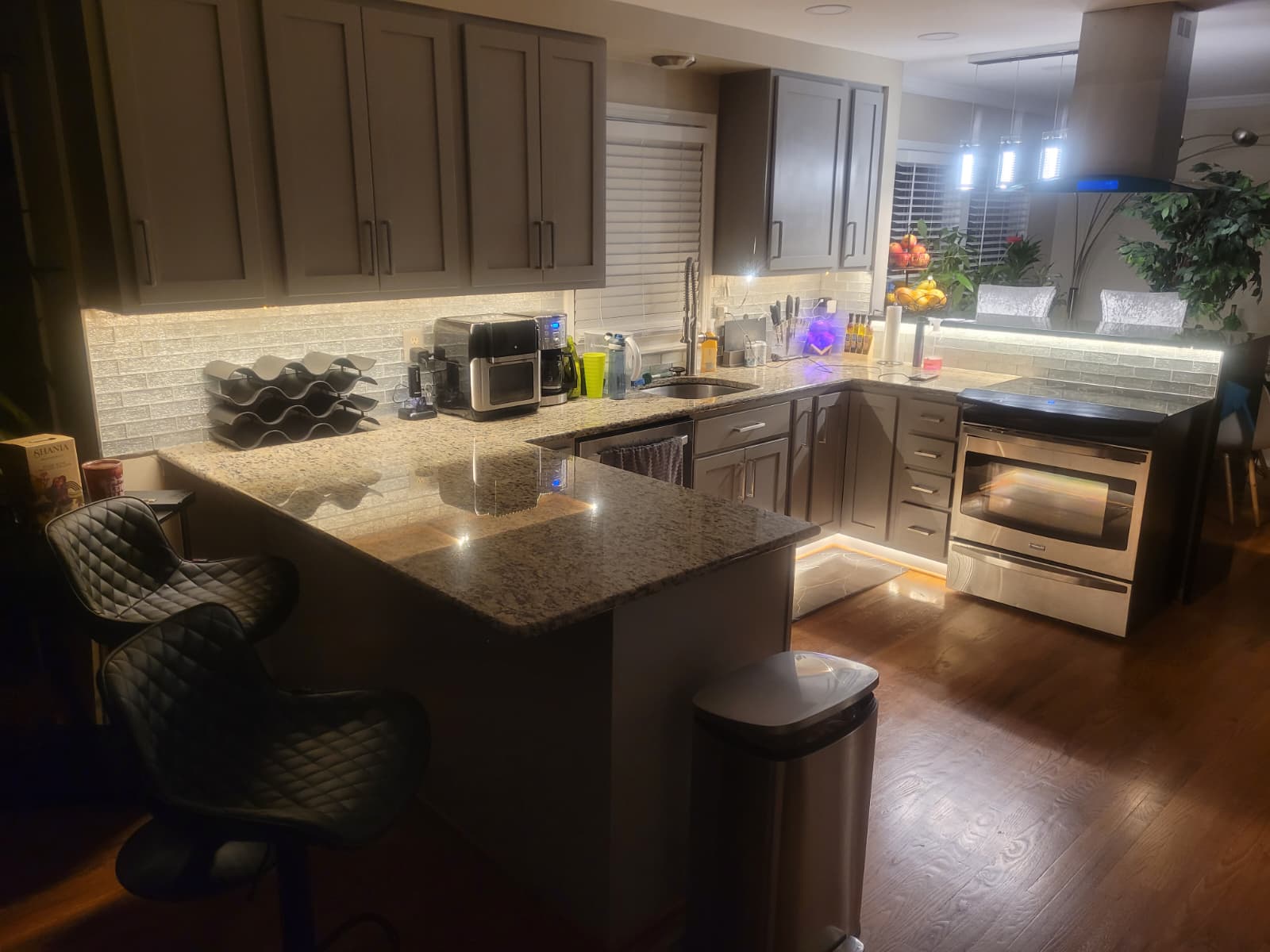 Gallery Newly remodeled kitchen with gray cabinetry and granite countertops by Perfectum Construction & Plumbing.