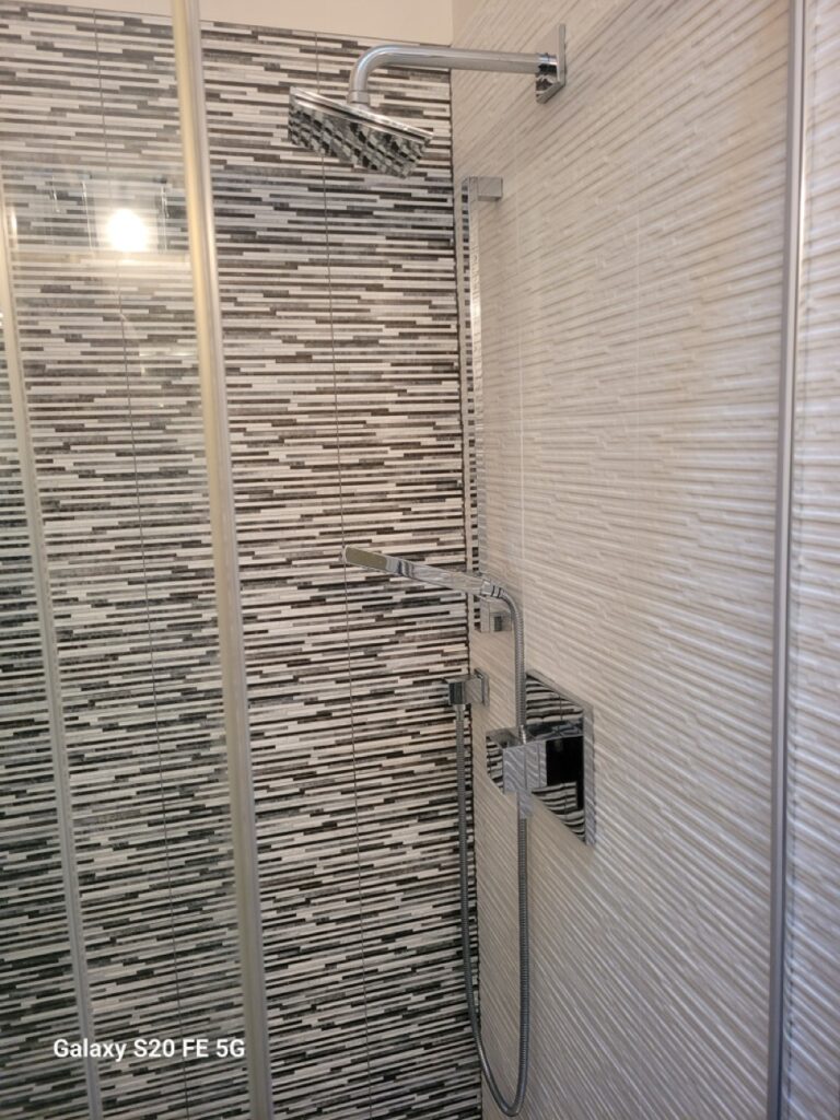 Home Modern shower with mosaic tile and high-end fixtures – Perfectum bathroom remodeling in Gaithersburg, MD.