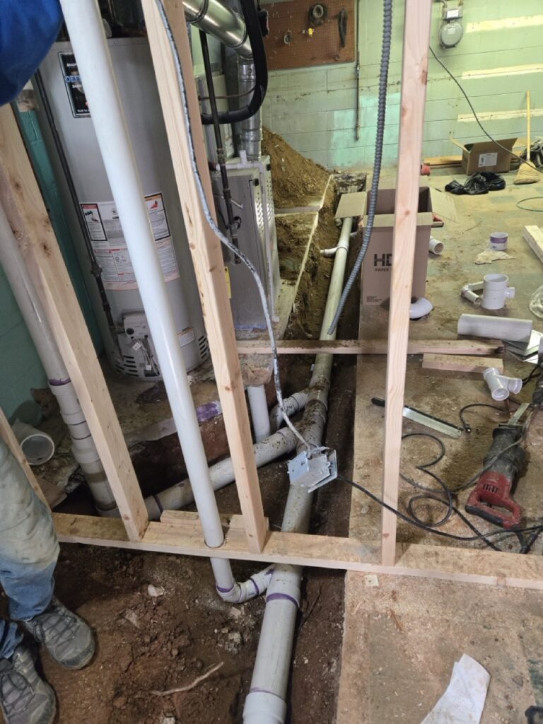 Home Basement plumbing renovation with new PVC drain lines and water heater installation by Perfectum in Gaithersburg, MD.