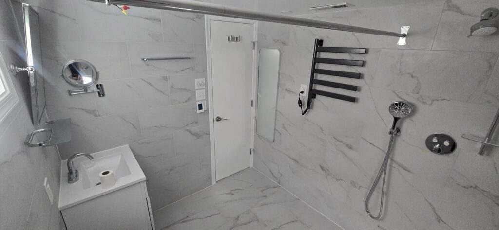 Gallery Newly remodeled bathroom with modern tile, fixtures, and walk-in shower by Perfectum Construction & Plumbing.