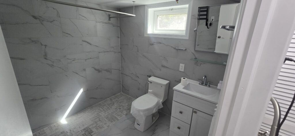 Gallery Completed bathroom remodel with tile shower and vanity by Perfectum Construction & Plumbing.