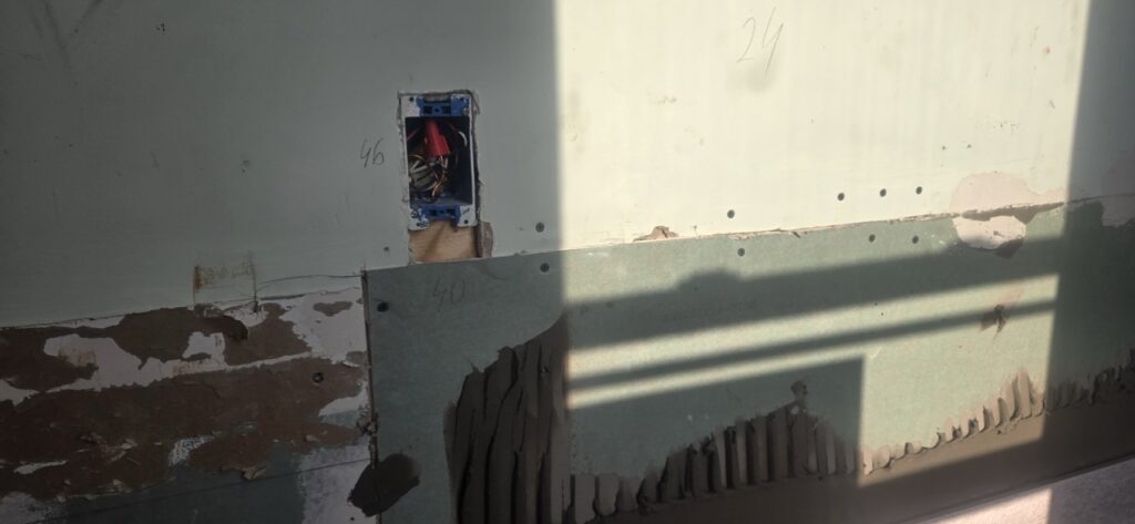 Gallery Electrical outlet and drywall during Perfectum Construction and Plumbing remodeling project.