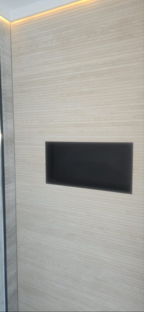 Gallery Bathroom remodel showcasing tile work and recessed shelf by Perfectum Construction & Plumbing.