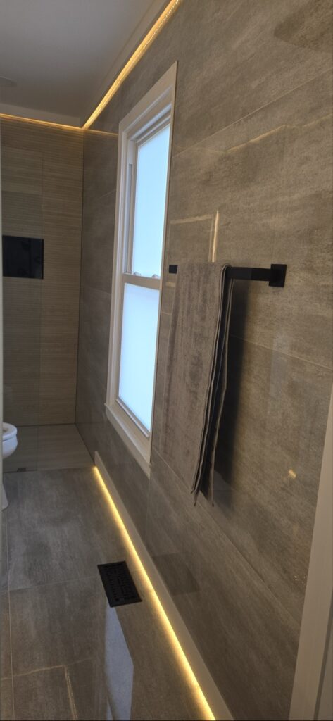 Gallery Bathroom remodel with tile walls, window, and recessed lighting by Perfectum Construction & Plumbing.
