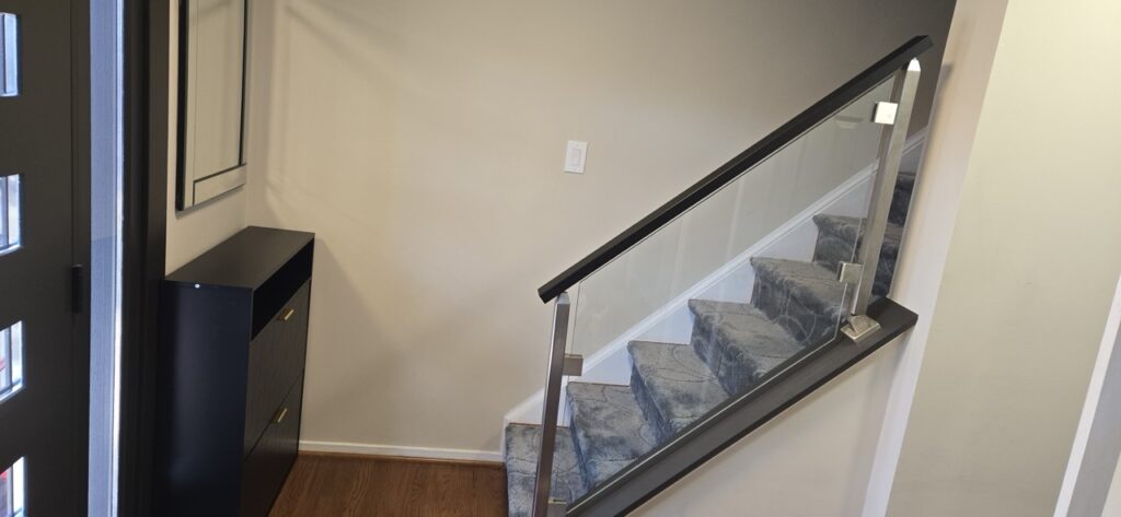 Gallery Gaithersburg, MD home remodeling project featuring modern staircase and glass railing.