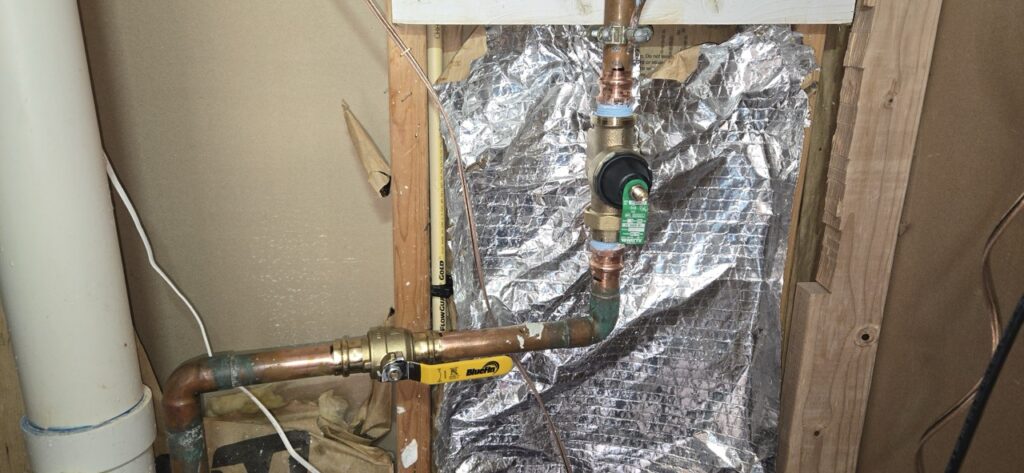 Gallery Plumbing installation and repairs featuring copper pipes and valve within wall during Perfectum Construction & Plumbing project.
