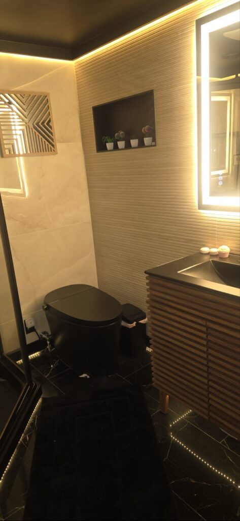 Gallery Stylish bathroom remodel with modern vanity, toilet, and recessed lighting by Perfectum Construction & Plumbing.