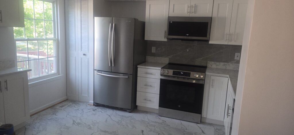 Gallery Newly remodeled kitchen with stainless steel appliances and white cabinetry in Gaithersburg, MD.