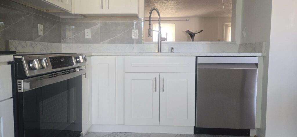 Gallery Newly remodeled kitchen with stainless steel appliances and modern fixtures by Perfectum Construction & Plumbing
