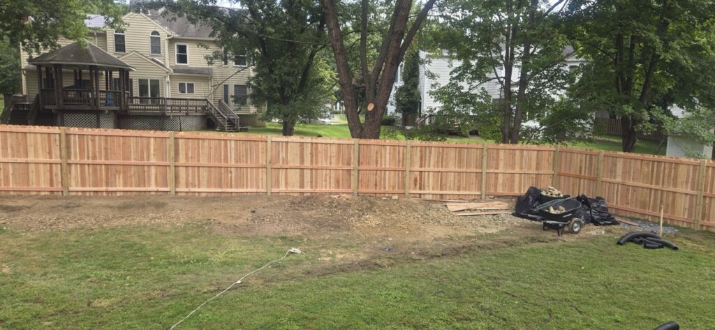 Gallery Newly installed wooden fence and landscaping in Gaithersburg, MD, showcasing Perfectum Construction & Plumbing remodeling project.