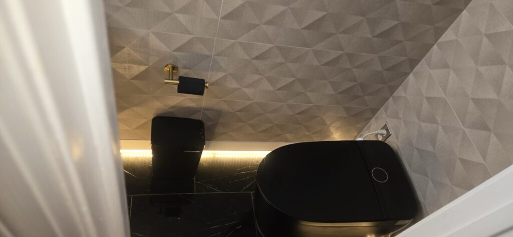 Gallery Stylish bathroom remodel with modern toilet and tilework by Perfectum Construction & Plumbing.