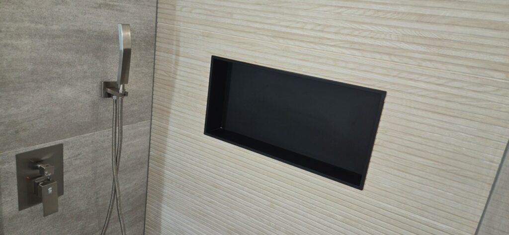 Gallery Newly remodeled bathroom with tile shower and built-in shelf by Perfectum Construction & Plumbing.