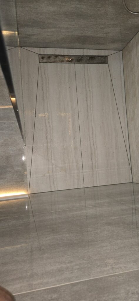 Gallery Marble tile shower remodel and restoration by Perfectum Construction & Plumbing.