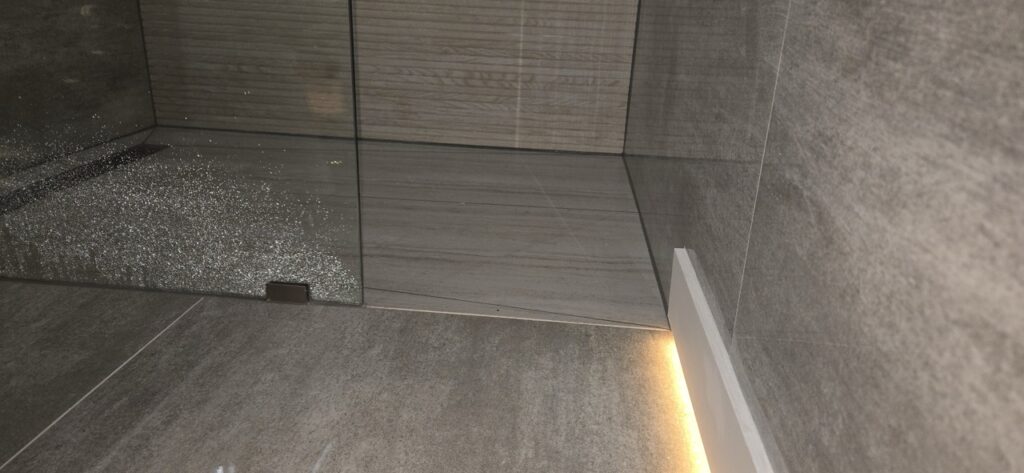 Gallery Modern bathroom remodel with tiled shower and glass enclosure by Perfectum Construction & Plumbing