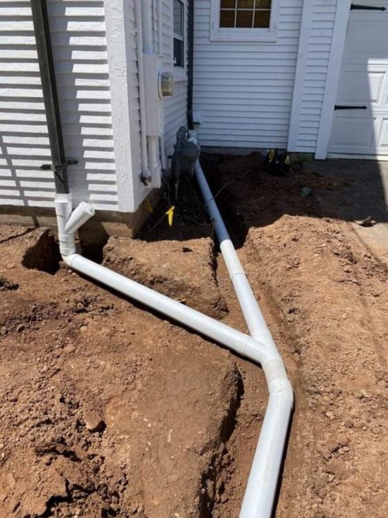 Home New plumbing installation and repair in Bethesda, MD, featuring PVC pipes and trench work.
